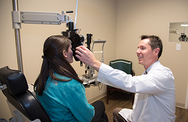 optometrist examining patient