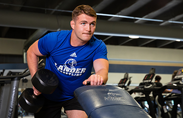student lifting weights