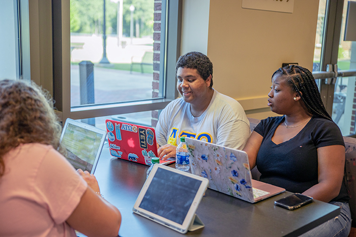 students at table with computers