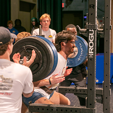 student lifting weights