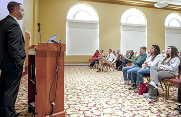 Matthew Malone speaking at lecture