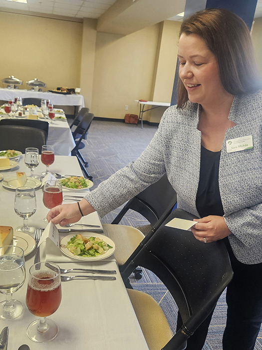 Sara McAda setting a table