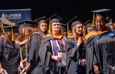 graduates at hooding ceremony