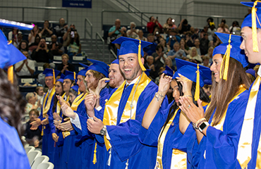 graduates at commencement