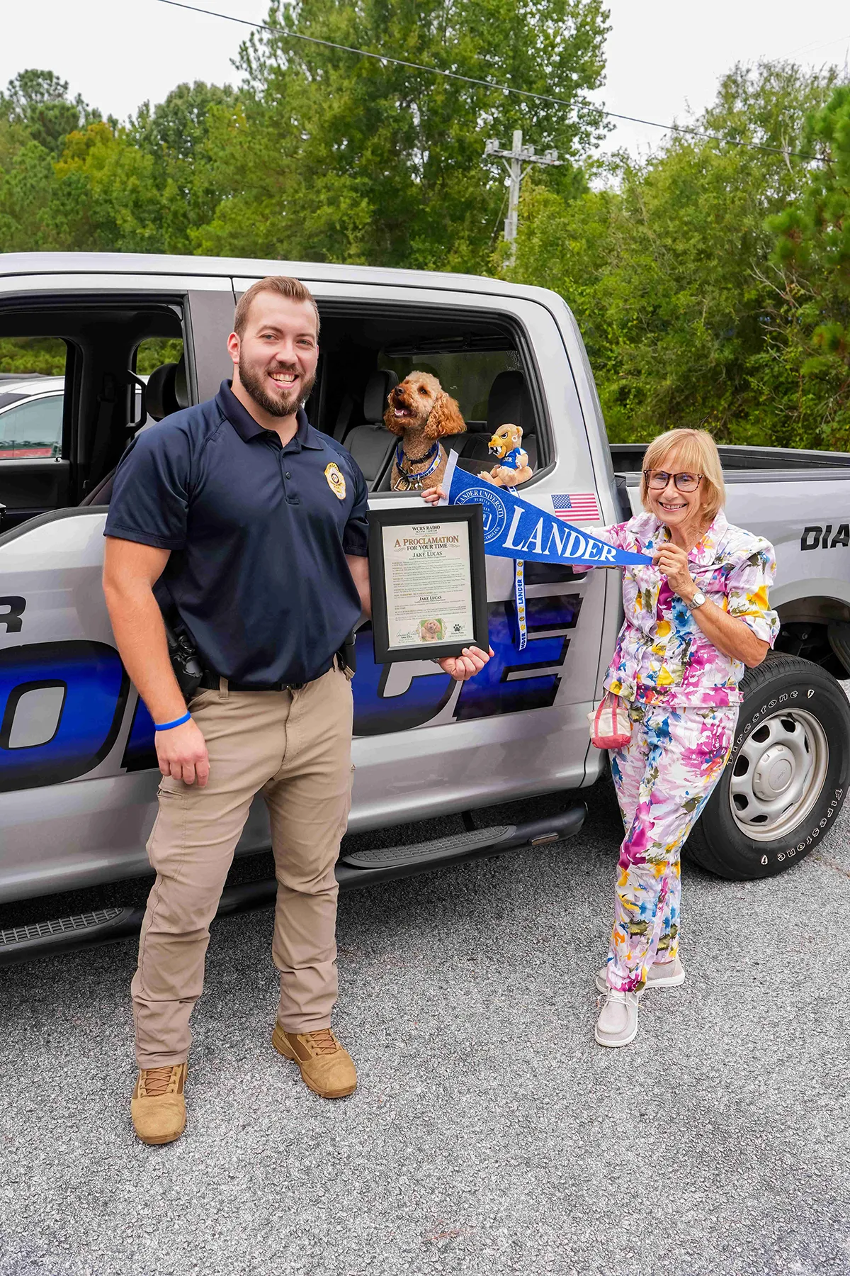 WCRS Radio owner and broadcaster, right, presents Lt. Jake Lucas, of the Lander University Police Department